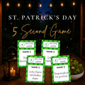 St. Patrick's Day 5 Second Game from Firefly Parade featuring green shamrock printable cards on a rustic table with lantern, clovers, and glowing string lights.